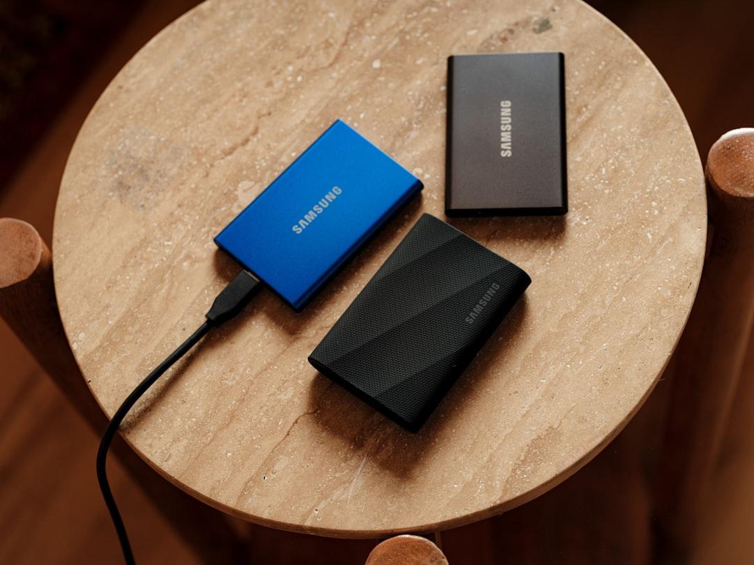 Stack of external hard drives, SSDs, and storage accessories on a desk