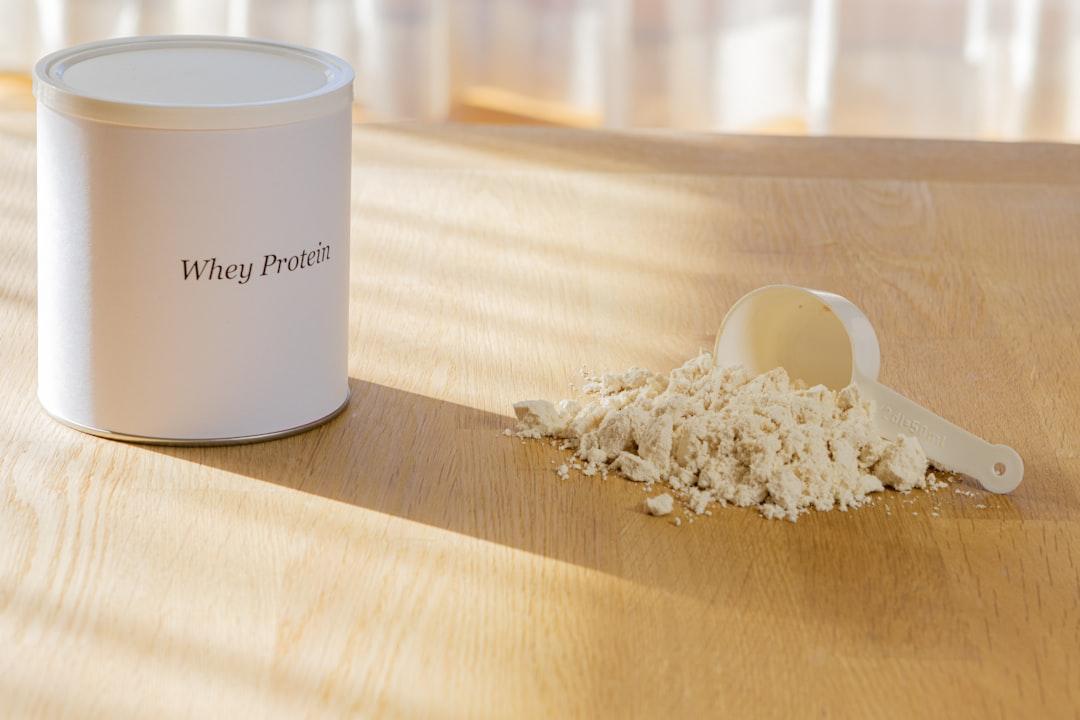 Measured supplement powder, coffee, and shaker bottle on a countertop